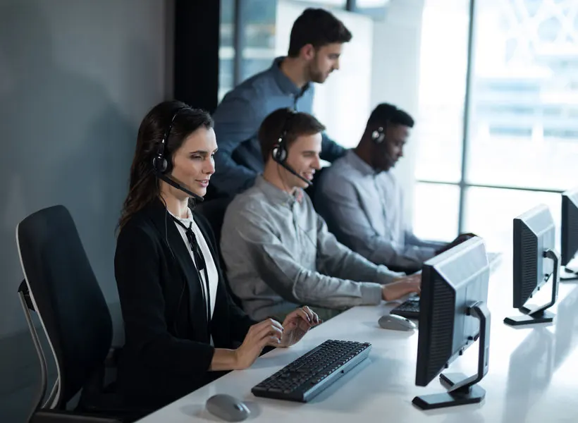 IT engineer monitoring systems on multiple screens