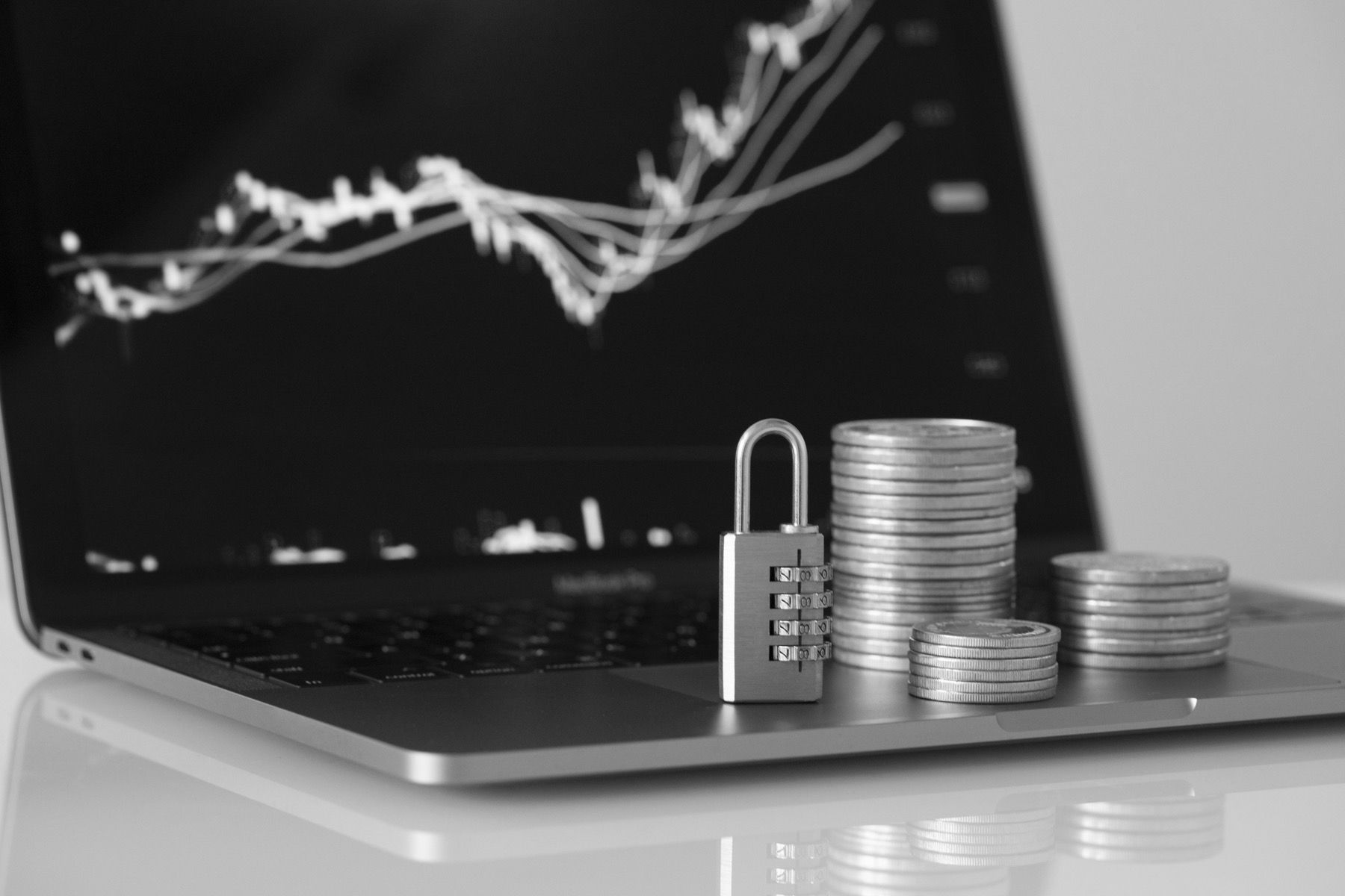 Padlock over coins representing cybersecurity for financial firms